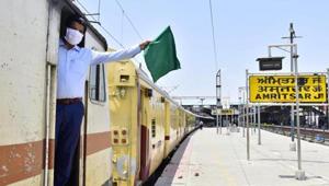 A railway guard waves the green flag aboard a Jaynagar Shaheed Express train at the Amritsar Junction as Indian Railways expand operations under lockdown on Monday.(Sameer Sehgal/HT Photo) A railway guard waves the green flag aboard a Jaynagar Shaheed Express train at the Amritsar Junction as Indian Railways expand operations under lockdown on Monday.(Sameer Sehgal/HT Photo)