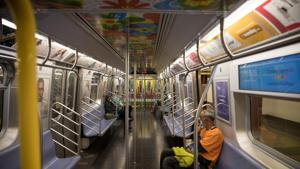 Commuters wear protective masks while riding the subway at Pennsylvania Station in New York, US on Monday.(Bloomberg) Commuters wear protective masks while riding the subway at Pennsylvania Station in New York, US on Monday.(Bloomberg)