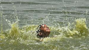 A boy swimming in the river Yamuna near Geeta Colony on a hot summer day, in New Delhi.(Sanchit Khanna/HT PHOTO)