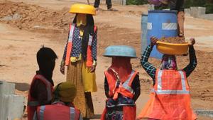Women labourers in traditional attire and safety jackets use tagari pans to shield from the sun while working at the construction site of an elevated road, in Jaipur, Rajasthan on Wednesday.(Himanshu Vyas/HT Photo) Women labourers in traditional attire and safety jackets use tagari pans to shield from the sun while working at the construction site of an elevated road, in Jaipur, Rajasthan on Wednesday.(Himanshu Vyas/HT Photo)
