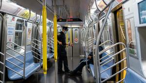 A New York City Police (NYPD) officer wearing a protective mask asks a rider to exit the train so it can be disinfected at the 2nd Ave-96th Street subway station in New York, US on Wednesday(Bloomberg File Photo) A New York City Police (NYPD) officer wearing a protective mask asks a rider to exit the train so it can be disinfected at the 2nd Ave-96th Street subway station in New York, US on Wednesday(Bloomberg File Photo)