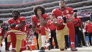 In this Oct. 2, 2016, file photo, from left, San Francisco 49ers outside linebacker Eli Harold, quarterback Colin Kaepernick and safety Eric Reid kneel during the national anthem before an NFL football game against the Dallas Cowboys in Santa Clara.(AP) In this Oct. 2, 2016, file photo, from left, San Francisco 49ers outside linebacker Eli Harold, quarterback Colin Kaepernick and safety Eric Reid kneel during the national anthem before an NFL football game against the Dallas Cowboys in Santa Clara.(AP)