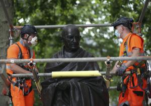 Workers put up a protective screen around the statue of Mahatma Gandhi in Parliament Square ahead of expected rival demonstrations by anti-racism and far-right protesters in London, Friday, June 12, 2020.(AP) Workers put up a protective screen around the statue of Mahatma Gandhi in Parliament Square ahead of expected rival demonstrations by anti-racism and far-right protesters in London, Friday, June 12, 2020.(AP)