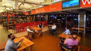 People at the food court of a mall in New Delhi. In the post-Covid-19 world, shopping malls will become “warehouses of e-commerce”, according to a white paper of the West Bengal goverment.(Amal KS / HT File Photo) People at the food court of a mall in New Delhi. In the post-Covid-19 world, shopping malls will become “warehouses of e-commerce”, according to a white paper of the West Bengal goverment.(Amal KS / HT File Photo)