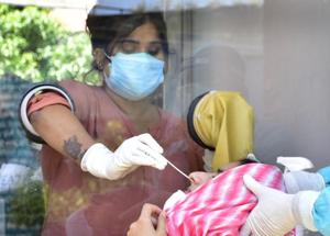 A health worker collecting a nasal swab sample from a woman, to test for the coronavirus disease, at the Civil Hospital in Amritsar on Monday.(Sameer Sehgal/HT) A health worker collecting a nasal swab sample from a woman, to test for the coronavirus disease, at the Civil Hospital in Amritsar on Monday.(Sameer Sehgal/HT)