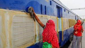 A worker cleans a train coach, temporarily converted into isolation wards for Covid-19 patients in New Delhi on Monday.Hotels and banquet halls are being converted into wards to accomodate the rising number of COVID-19 patients.(PTI) A worker cleans a train coach, temporarily converted into isolation wards for Covid-19 patients in New Delhi on Monday.Hotels and banquet halls are being converted into wards to accomodate the rising number of COVID-19 patients.(PTI)