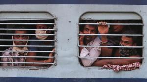 Migrant workers look out a train window before moving to their home states, at a railway station in Hyderabad, India.(AP) Migrant workers look out a train window before moving to their home states, at a railway station in Hyderabad, India.(AP)
