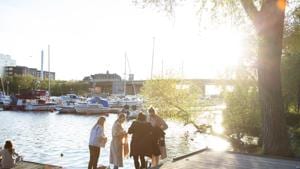 A group of people socialize on a jetty on the water's edge at Tantolunden in Stockholm, Sweden. Sweden says its approach was based on an assumption that Covid-19 will be around for a while yet, meaning severe temporary lockdowns will do little to prevent its spread in the long run.(Bloomberg) A group of people socialize on a jetty on the water's edge at Tantolunden in Stockholm, Sweden. Sweden says its approach was based on an assumption that Covid-19 will be around for a while yet, meaning severe temporary lockdowns will do little to prevent its spread in the long run.(Bloomberg)