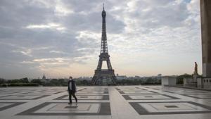 A man wears a mask to protect against the spread of the coronavirus as he walks along the Trocadero square in front of the Eiffel Tower in Paris.(AP) A man wears a mask to protect against the spread of the coronavirus as he walks along the Trocadero square in front of the Eiffel Tower in Paris.(AP)