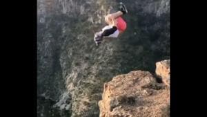 The image shows the man backflipping on the edge of a cliff.(Screengrab) The image shows the man backflipping on the edge of a cliff.(Screengrab)