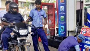 File photo: A fuel station attendant fills out the prices on board, in Guwahati.(PTI) File photo: A fuel station attendant fills out the prices on board, in Guwahati.(PTI)