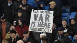 A fan holds up a banner against Video Assistant Referee (VAR) during the English Premier League soccer match.(AP)