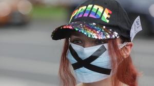 A girl wearing a PRIDE cap and a face mask bearing a black X attends an LGBT event outside the president's office to urge him to send a bill banning gender identity studies back to parliament, in Bucharest, Romania.(REUTERS) A girl wearing a PRIDE cap and a face mask bearing a black X attends an LGBT event outside the president's office to urge him to send a bill banning gender identity studies back to parliament, in Bucharest, Romania.(REUTERS)