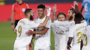 Real Madrid's Karim Benzema, left, celebrates with his teammates after scoring his side's third goal during the Spanish La Liga soccer match between Real Madrid and Valencia at Alfredo di Stefano stadium in Madrid, Spain, Thursday, June 18, 2020. Real Madrid won 3-0. (AP Photo/Manu Fernandez)(AP) Real Madrid's Karim Benzema, left, celebrates with his teammates after scoring his side's third goal during the Spanish La Liga soccer match between Real Madrid and Valencia at Alfredo di Stefano stadium in Madrid, Spain, Thursday, June 18, 2020. Real Madrid won 3-0. (AP Photo/Manu Fernandez)(AP)