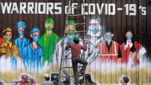 A man gets off a ladder as he completes a mural paying tribute to 'Covid-19 warriors' as India eases lockdown restrictions that were imposed to slow the spread of the coronavirus disease(REUTERS) A man gets off a ladder as he completes a mural paying tribute to 'Covid-19 warriors' as India eases lockdown restrictions that were imposed to slow the spread of the coronavirus disease(REUTERS)