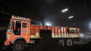 A worker shovels coal in a supply truck at a yard on the outskirts of Ahmedabad.(REUTERS) A worker shovels coal in a supply truck at a yard on the outskirts of Ahmedabad.(REUTERS)