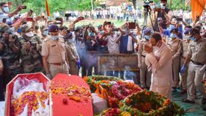 Madhya Pradesh Chief Minister Shivraj Singh Chouhan pays his respects to Naib Dipak Singh before his cremation at his native village Farenda in Rewa District on Friday.(PTI) Madhya Pradesh Chief Minister Shivraj Singh Chouhan pays his respects to Naib Dipak Singh before his cremation at his native village Farenda in Rewa District on Friday.(PTI)