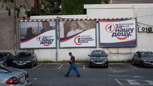 A man walks past election campaign posters of ruling Serbian Progressive Party in Belgrade, Serbia.(REUTERS)