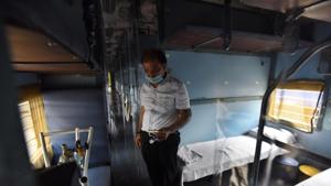 An Indian Railways staff notes down details inside a train coach--temporarily converted into an isolation ward for coronavirus patients, at Anand Vihar railway station in New Delhi on Saturday.(Raj K Raj/HT Photo) An Indian Railways staff notes down details inside a train coach--temporarily converted into an isolation ward for coronavirus patients, at Anand Vihar railway station in New Delhi on Saturday.(Raj K Raj/HT Photo)