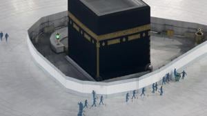 Workers disinfect the ground around the Kaaba, the cubic building at the Grand Mosque, in the Muslim holy city of Mecca, Saudi Arabia after authorities emptied Islam's holiest site for sterilization over fears of the new coronavirus.(AP File Photo) Workers disinfect the ground around the Kaaba, the cubic building at the Grand Mosque, in the Muslim holy city of Mecca, Saudi Arabia after authorities emptied Islam's holiest site for sterilization over fears of the new coronavirus.(AP File Photo)