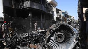 In this photo taken on May 24, 2020, security personnel stand beside the wreckage of a plane at the site after a Pakistan International Airlines aircraft crashed in a residential area days before, in Karachi.(AFP) In this photo taken on May 24, 2020, security personnel stand beside the wreckage of a plane at the site after a Pakistan International Airlines aircraft crashed in a residential area days before, in Karachi.(AFP)