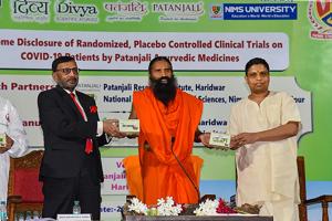 Baba Ramdev along with Acharya Balkrishna launches an Ayurvedic medicine kit that they claimed can treat coronavirus patients within seven days.(@PypAyurved/Twitter)