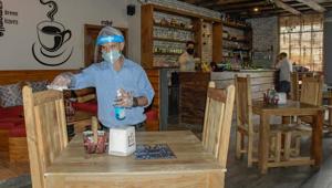 An employee at a restaurant sanitising the furniture ahead of the reopening of the outlet in Ludhiana on Wednesday.(Harsimar Pal Singh/HT) An employee at a restaurant sanitising the furniture ahead of the reopening of the outlet in Ludhiana on Wednesday.(Harsimar Pal Singh/HT)