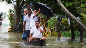 People move to safer place in a boat after floodwater enters the town in Assam’s Dibrugarh on Thursday(ANI Photo) People move to safer place in a boat after floodwater enters the town in Assam’s Dibrugarh on Thursday(ANI Photo)