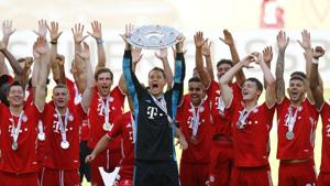 Bayern Munich's Manuel Neuer celebrates with the trophy and teammates after winning the Bundesliga. Bayern Munich's Manuel Neuer celebrates with the trophy and teammates after winning the Bundesliga.