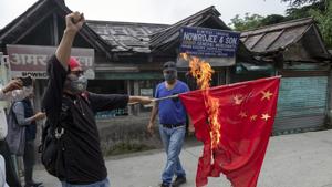 Tenzin Tsundue, an exile Tibetan activist burns a Chinese national flag during a one-man protest in Dharmsala, India.(AP) Tenzin Tsundue, an exile Tibetan activist burns a Chinese national flag during a one-man protest in Dharmsala, India.(AP)