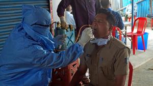 A health worker collect swab sample of a police personnel for Covid-19 test in Bhubaneswar.(ANI) A health worker collect swab sample of a police personnel for Covid-19 test in Bhubaneswar.(ANI)