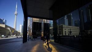 A pedestrian walks on the sidewalk in the financial district of Toronto, Ontario, Canada.(Bloomberg) A pedestrian walks on the sidewalk in the financial district of Toronto, Ontario, Canada.(Bloomberg)