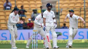 India's Virat Kohli looks on as Australian cricketers celebrate his dismissal during the first day of the second test match at Chinnaswamy Stadium in Bengaluru.(PTI) India's Virat Kohli looks on as Australian cricketers celebrate his dismissal during the first day of the second test match at Chinnaswamy Stadium in Bengaluru.(PTI)