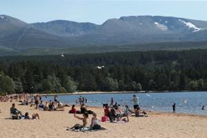 People enjoy the hot weather on the beach at Loch Morlich, near Aviemore, Scotland, Britain.(REUTERS) People enjoy the hot weather on the beach at Loch Morlich, near Aviemore, Scotland, Britain.(REUTERS)