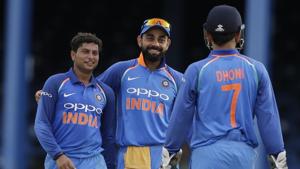 India's spin bowler Kuldeep Yadav, left, celebrates with captain Virat Kohli and wicket keeper MS Dhoni the dismissal of West Indies' captain Jason Holder.(AP) India's spin bowler Kuldeep Yadav, left, celebrates with captain Virat Kohli and wicket keeper MS Dhoni the dismissal of West Indies' captain Jason Holder.(AP)