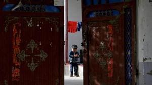 In this 2018 photo, a Uighur child plays alone in the courtyard of a home at the Unity New Village in Hotan, in western China's Xinjiang region.(AP photo) In this 2018 photo, a Uighur child plays alone in the courtyard of a home at the Unity New Village in Hotan, in western China's Xinjiang region.(AP photo)