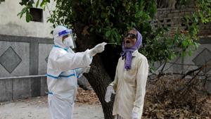 A healthcare worker collects a sample at a centre to conduct tests for the coronavirus disease in New Delhi on June 29.(Reuters Photo) A healthcare worker collects a sample at a centre to conduct tests for the coronavirus disease in New Delhi on June 29.(Reuters Photo)