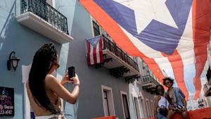 A tourist takes photos of a couple in front of the Governor's mansion in San Juan, Puerto Rico on June 30, 2020, during the coronavirus pandemic.(AFP) A tourist takes photos of a couple in front of the Governor's mansion in San Juan, Puerto Rico on June 30, 2020, during the coronavirus pandemic.(AFP)