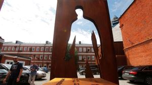 People walk past a monument honouring delivery couriers who continued to work throughout the outbreak of the coronavirus disease.(REUTERS) People walk past a monument honouring delivery couriers who continued to work throughout the outbreak of the coronavirus disease.(REUTERS)