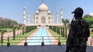 A Central Industrial Security Force (CISF) soldier stands guard inside the empty premises of the historic Taj Mahal in Agra.(REUTERS PHOTO.) A Central Industrial Security Force (CISF) soldier stands guard inside the empty premises of the historic Taj Mahal in Agra.(REUTERS PHOTO.)