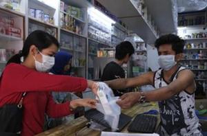 A girl buys surgical masks in Imphal, capital of the northeastern Indian state of Manipur.(AP) A girl buys surgical masks in Imphal, capital of the northeastern Indian state of Manipur.(AP)