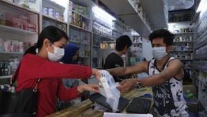 File photo: A girl buys surgical masks amid Covid-19 pandemic in Imphal, Manipur.(AP) File photo: A girl buys surgical masks amid Covid-19 pandemic in Imphal, Manipur.(AP)
