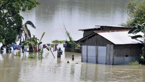A woman dries clothes as others swim in a flooded area of Morigaon, Assam, July 1. It is time the central and the state governments prepare a long-term plan that goes beyond piecemeal measures like building embankments and dredging to control floods(PTI) A woman dries clothes as others swim in a flooded area of Morigaon, Assam, July 1. It is time the central and the state governments prepare a long-term plan that goes beyond piecemeal measures like building embankments and dredging to control floods(PTI)