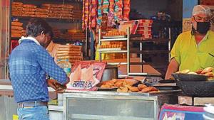 A man feasts on sweets at a sweet shop in Agra.(HT photos) A man feasts on sweets at a sweet shop in Agra.(HT photos)