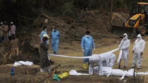 The video showed sanitation staff of the Tirupati Municipal Corporation lifting the body of the Covid-19 victim using the earth mover and dumping it into an already dug pit in the graveyard.(AP file photo. Representative image) The video showed sanitation staff of the Tirupati Municipal Corporation lifting the body of the Covid-19 victim using the earth mover and dumping it into an already dug pit in the graveyard.(AP file photo. Representative image)