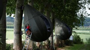 A guest climbs on a ladder to enter a tear drop-shaped tent hanging from a tree created by Dutch artist Dre Wapenaar, offering an unusual accommodation for tourists in the Belgian countryside, near Borgloon, Belgium.(REUTERS/Francois Lenoir) A guest climbs on a ladder to enter a tear drop-shaped tent hanging from a tree created by Dutch artist Dre Wapenaar, offering an unusual accommodation for tourists in the Belgian countryside, near Borgloon, Belgium.(REUTERS/Francois Lenoir)