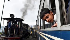 A boy looks out of a Darjeeling Himalayan Railway train, one of the main tourist draws in Darjeeling.(REUTERS) A boy looks out of a Darjeeling Himalayan Railway train, one of the main tourist draws in Darjeeling.(REUTERS)