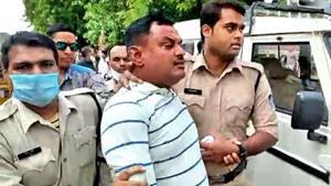 Police personnel arrest Vikas Dubey, the main accused in the Kanpur encounter case, at the Mahakal temple, in Ujjain on Thursday.(ANI photo) Police personnel arrest Vikas Dubey, the main accused in the Kanpur encounter case, at the Mahakal temple, in Ujjain on Thursday.(ANI photo)