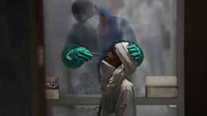 A health worker takes a nasal swab of a person for a Covid-19 test at a hospital in New Delhi, India, Monday, July 6, 2020.(AP) A health worker takes a nasal swab of a person for a Covid-19 test at a hospital in New Delhi, India, Monday, July 6, 2020.(AP)