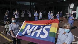 NHS staff outside Royal Victoria Infirmary join in the pause for applause to salute the NHS 72nd birthday, in Newcastle, England, Sunday, July 5, 2020.(AP) NHS staff outside Royal Victoria Infirmary join in the pause for applause to salute the NHS 72nd birthday, in Newcastle, England, Sunday, July 5, 2020.(AP)